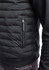A men's tailored jacket in black with a zippered pocket and a quilted design on the front.