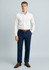 A model wearing navy flat front slacks paired with a white shirt and brown belt, set against a light background.