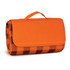 An orange picnic blanket with a checkered pattern, compactly folded with a carry handle.