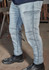 A pair of light blue stretch jeans with cargo-style pockets, worn with black work boots.
