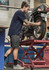 A man in navy blue shorts works on a motorcycle, showcasing rugged cooling stretch cargo shorts with pockets.