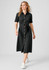 A black midi dress with a button-down front, short sleeves, and a belt, paired with white sneakers.