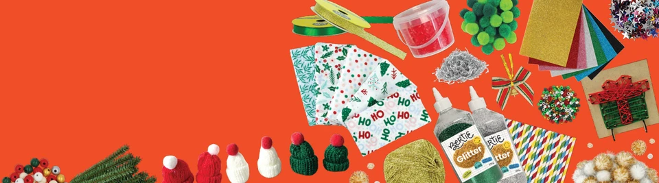 Christmas craft supplies including glitter glue, pom poms, mini beanies, ribbon, festive paper and pipe cleaners