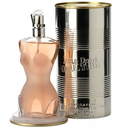 Perfumes Wholesale Jean Paul Gaultier perfume bottle in pink glass beside silver and gold tin container, 100ml.