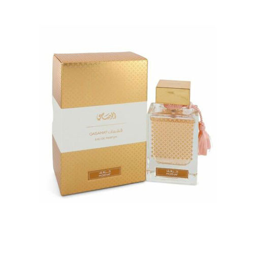 Perfumes Wholesale RASASI Qasamat Morhaf unisex perfume bottle 60ml EDP with golden packaging and pink ribbon.