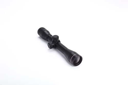 High angled studio shot of black Mazz Optics E4x32 compact riflescope isolated on a bright white background