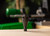 Full perspective view of the green and black motorized RCBS MatchMaster case trimmer unit mounted with its brass catching bin.
