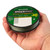 Close-up view of a person holding a spool of dark green SpiderWire Stealth Smooth braided fishing line in their hand