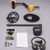 Disassembled parts of a Garrett ACE 300i metal detector kit laid out flat on a grey background. Includes the yellow control unit assembly, an oval searchcoil, a protective coil cover, a mid-stem shaft, headphones, a black fabric pouch, manuals, and mounting hardware.