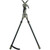 An isolated studio shot of the Primos Trigger Stick Gen 3 Tall Bipod standing on a black background. Features an olive drab green and black ergonomic handle grip with an integrated pull trigger, a rubberized top V-yoke, two adjustable dark gray aluminum legs, and textured rubber feet.