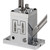 A close-up studio shot of the Hornady Versa-Prime Bench Tool housing on a white background. The bright aluminum block features a large engraved letter H logo with graphic icons of small and large primers inside, alongside an operational side lever, base plate mounting holes, and top assembly screws.
