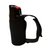 A close-up studio product shot of Counter Assault dog spray housed in its black fabric jogger-style holster, isolated on a white background. The canister features a glossy black actuator top with a bright red thumb trigger safety tab, while the tactical sleeve includes an adjustable black hook-and-loop hand strap looping outwards to the right.