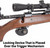 Detail view of black trigger lock mounted onto a bolt-action rifle with riflescope