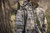 Close-up of a hunter in camouflage apparel carrying a rifle equipped with a black Browning sling outdoors