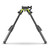 Front low-angle view of a black MDT GRND-POD Picatinny bipod with extended legs and green accent frame inside a square border on a white background