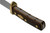 Close-up perspective shot highlighting the textured sawcut handle pommel and brass guard of the Old Timer knife