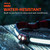 Close-up of the illuminated headlamp resting on wet wood paneling with overlay text reading Water-Resistant