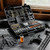 Elevated lifestyle shot of the open Mossberg gun cleaning tool kit spread across a dark wooden table surface