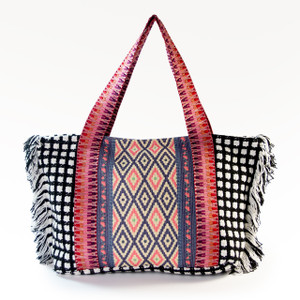 The vibrant, Indy Fringe Large Boho Tote, featuring a bold mix of woven geometric and checkered patterns with playful fringe detailing, is shown against a plain white background. The vibrant, Indy Fringe Large Boho Tote, featuring a bold mix of woven geometric and checkered patterns with playful fringe detailing, is shown against a plain white background.