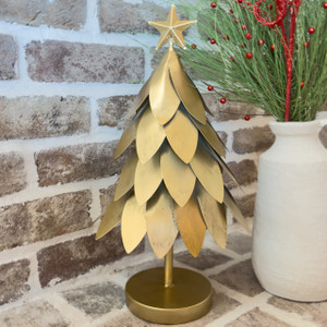 Gold metal leaves Christmas tree centerpiece with star topper on a round base, styled on a brick-backed mantel