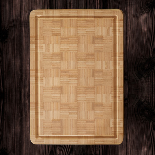 A rectangular bamboo end grain cutting board with a perimeter well, showcasing its distinctive block pattern, placed on a dark wooden surface.