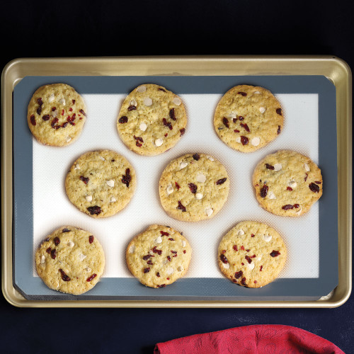 Cookies on a nonstick silicone baking mat lining a sheet pan