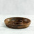 The empty acacia wood chip and dip platter is shown from a side angle, highlighting its rich end-grain construction and the built-in central bowl.