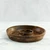 The empty acacia wood chip and dip platter is shown from a side angle, highlighting its rich end-grain construction and the built-in central bowl.
