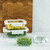 The set of three glass storage containers filled with fresh ingredients are shown in a modern kitchen setting, with two stacked to demonstrate their space-saving design.