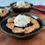 Three Gold No. 5 cast iron mini skillets are presented on a wooden board, each containing a delicious, single-serving blueberry dessert with a decorative leaf-patterned crust and topped with a scoop of vanilla ice cream.