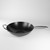 A side profile view of the wok, emphasizing its deep, curved shape and the stable base suitable for various stovetops.