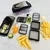Mandoline and chopper set laid out with all accessories: hand guard, catch container, blade inserts, and cleaning brush