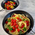 A close-up of the 8-inch cast iron fry pan filled with sautéed cherry tomatoes and leeks, showcasing the food prepared in the pan.