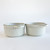 Pair of embossed stoneware soup bowls side by side, showing interior and exterior texture