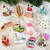 Holiday igloo glass ornament shown with other ornaments, ready for gifting
