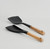 Two-piece silicone and acacia utensil set—rectangular spatula and angled cooking spoon on a neutral background