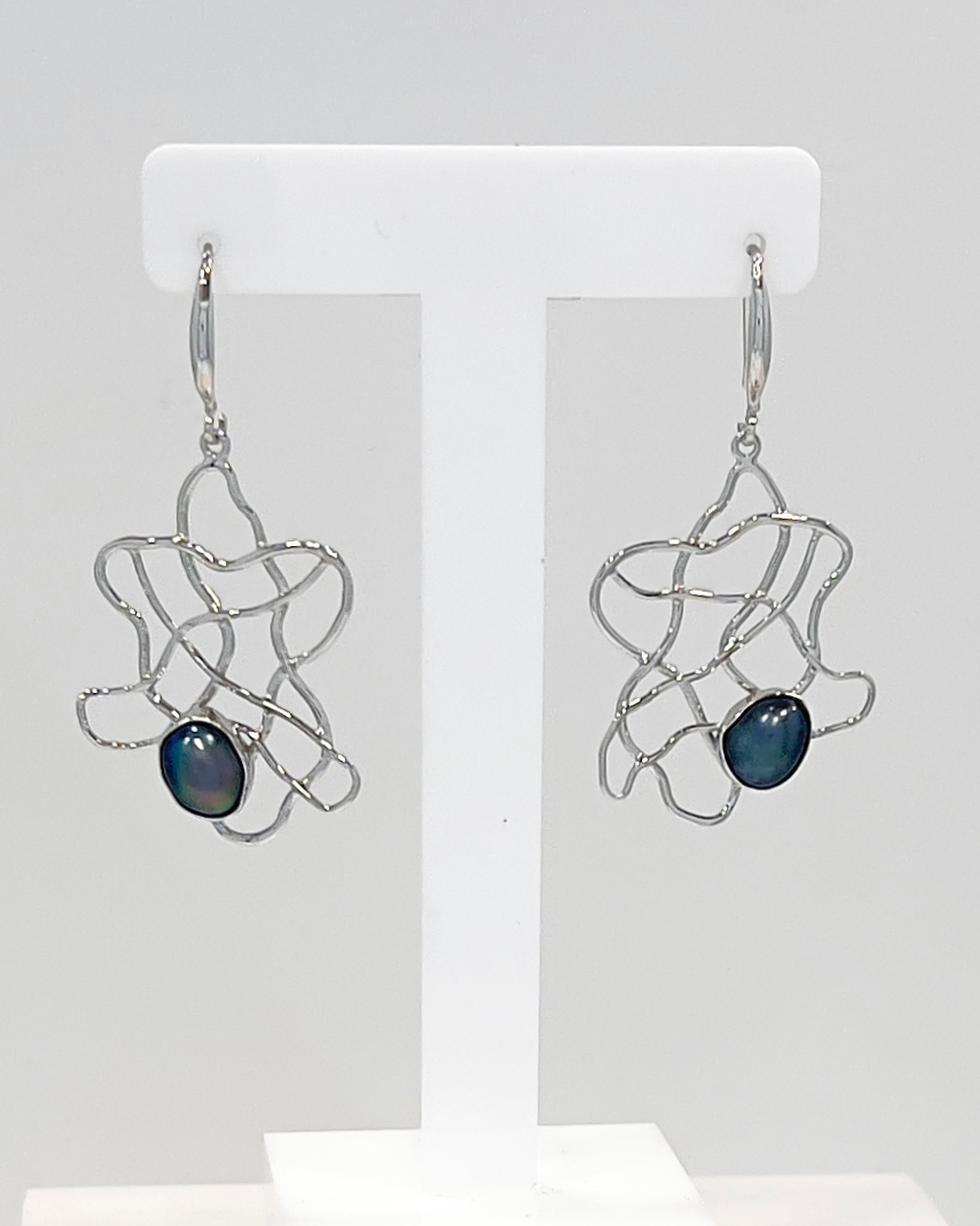 Elegant drop earrings with delicate keshi pearls nestled within a flowing silver wave lattice design