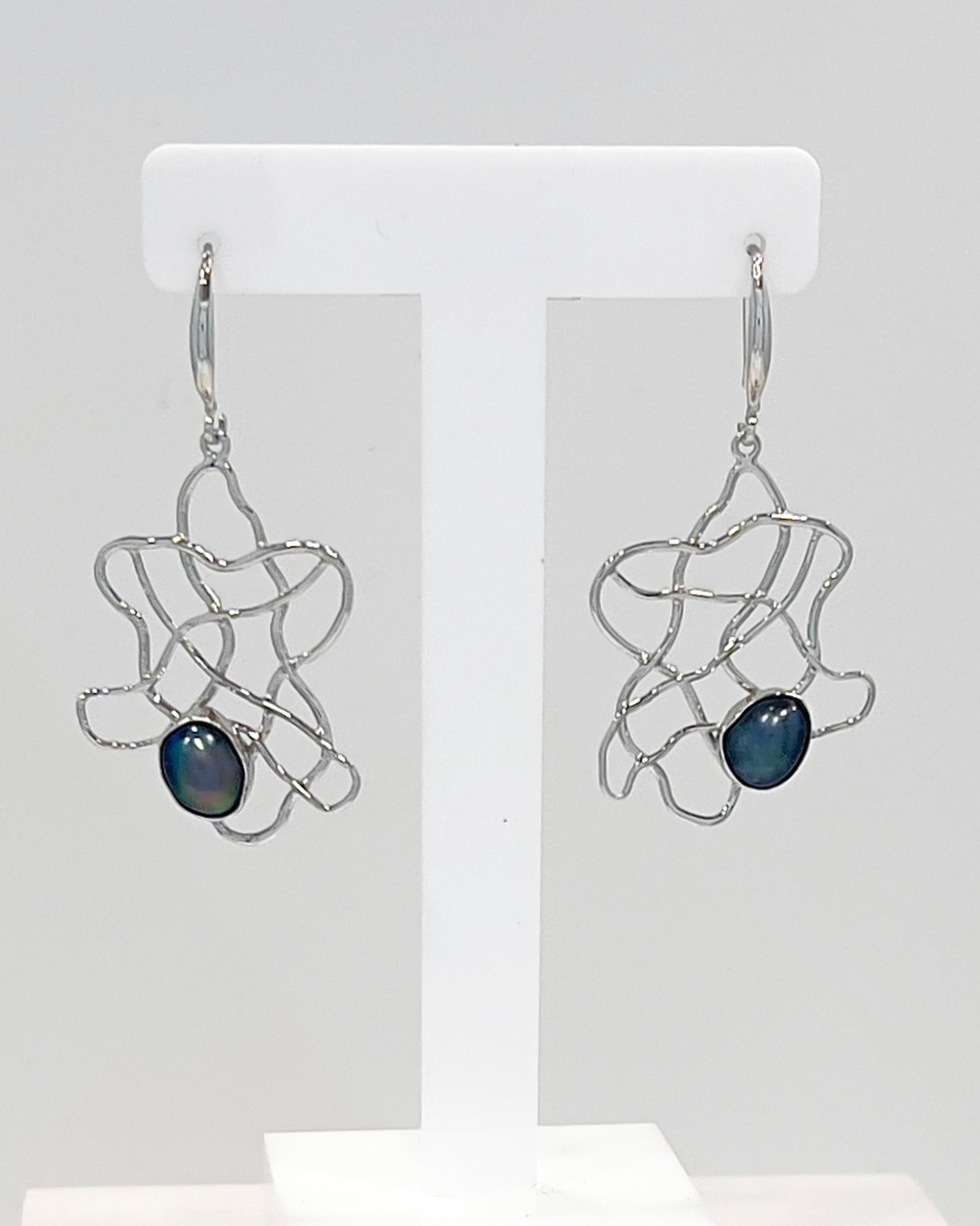 Keshi pearls nestled within a flowing silver wave lattice design