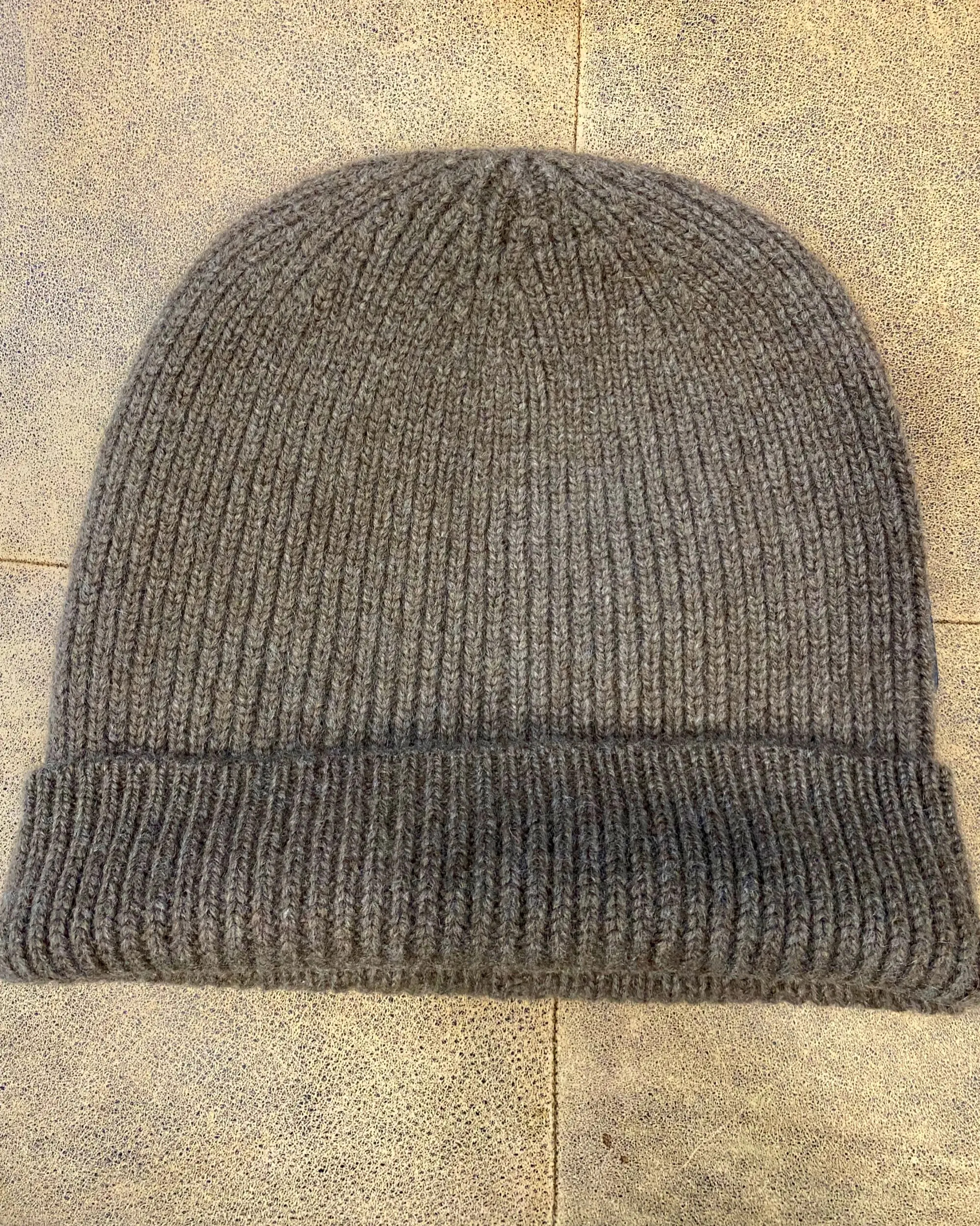 Lay flat view of unisex ribbed yak wool hat in brown