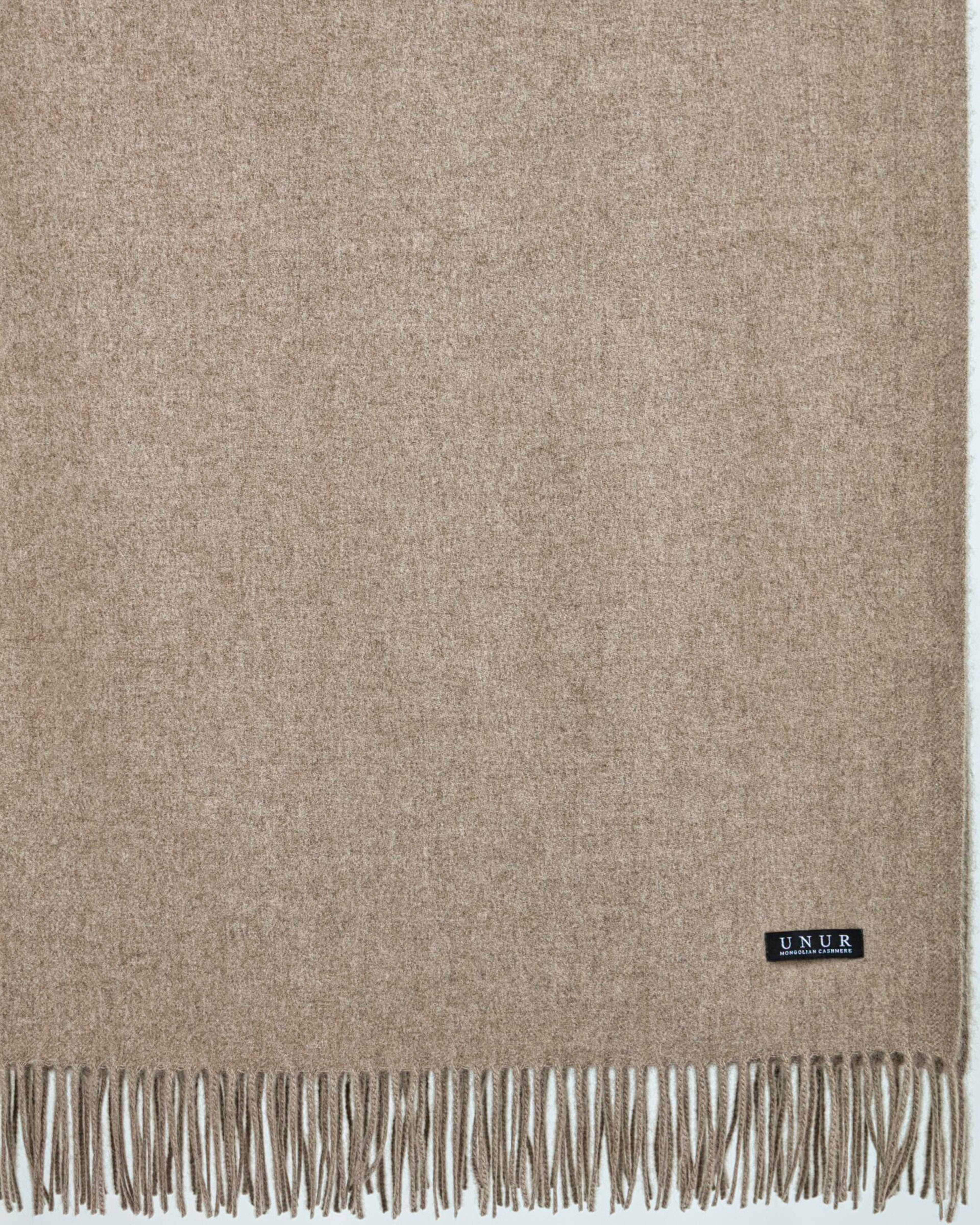 Close up of natural cashmere blanket in natural brown with delicate finished edges
