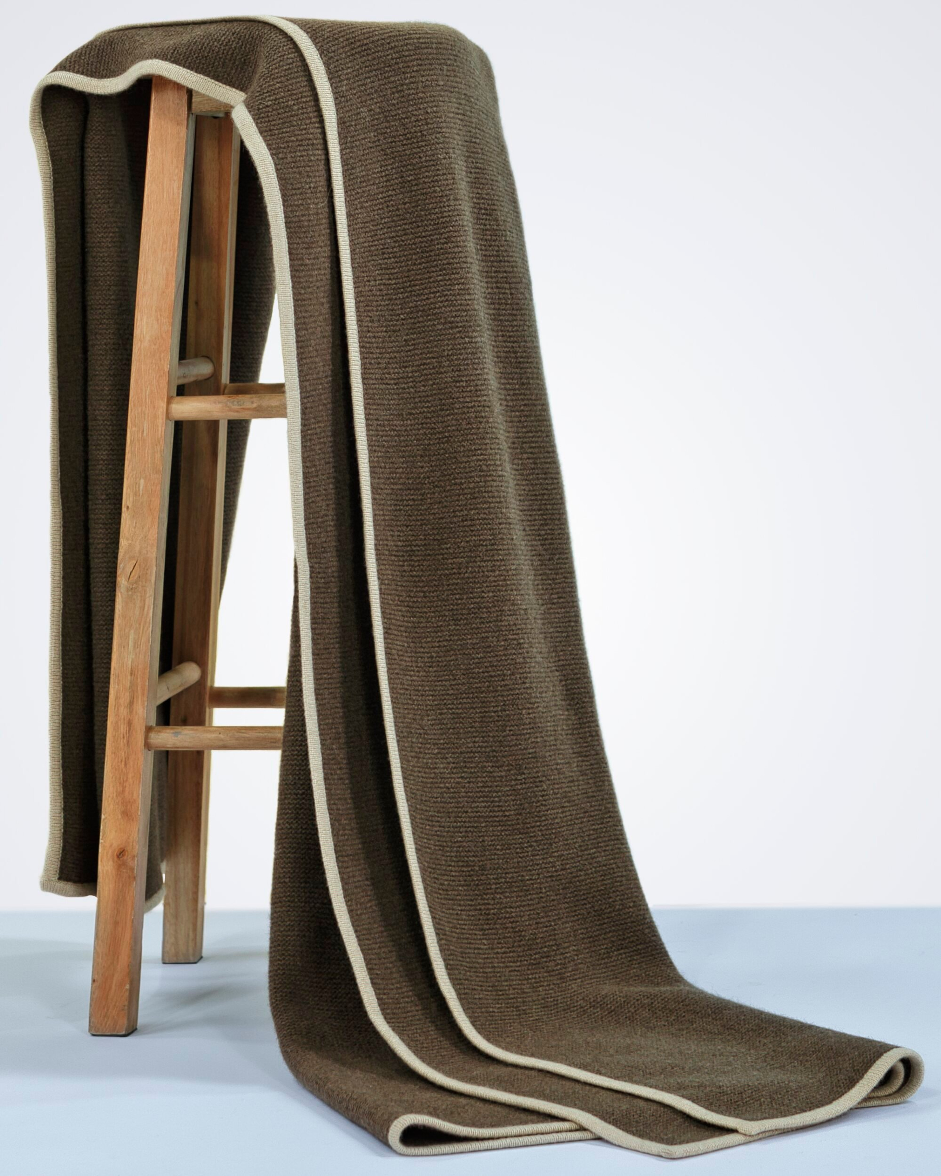 Natural brown yak wool blanket, draped over a chair