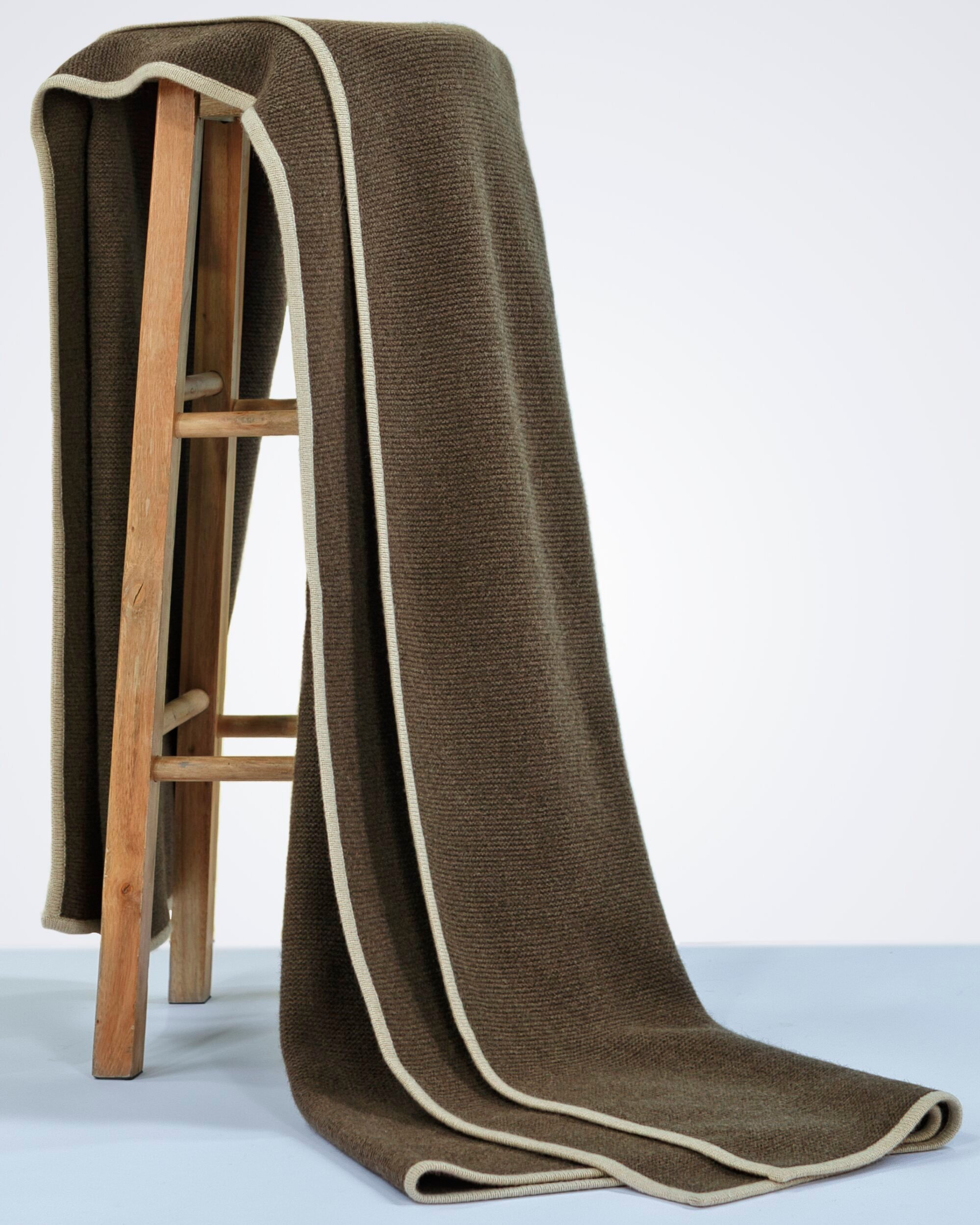 luxury rib-knit natural brown yak wool blanket draped over a chair