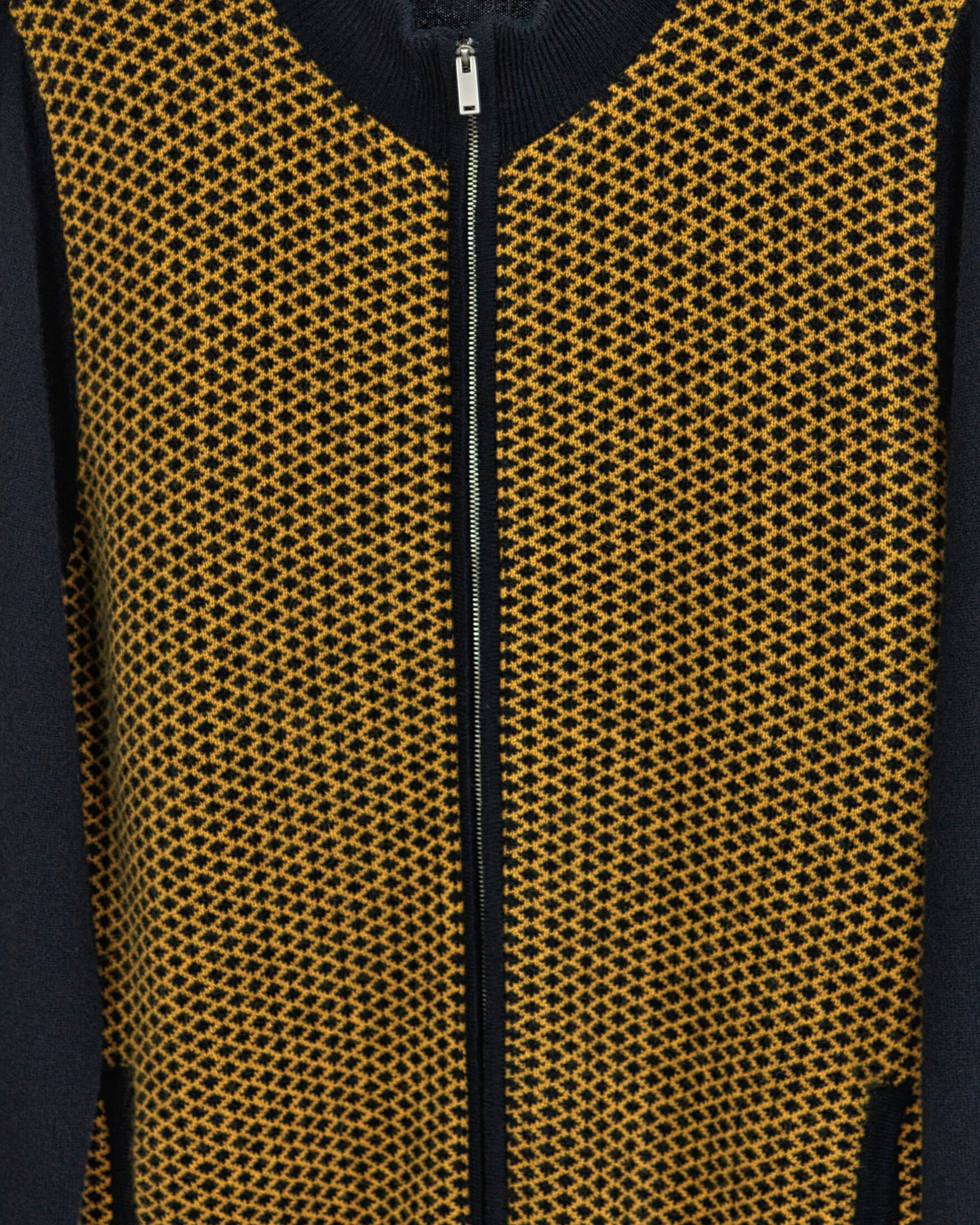 Close up of a men's two-tone cashmere cardigan with a diamond pattern in brown