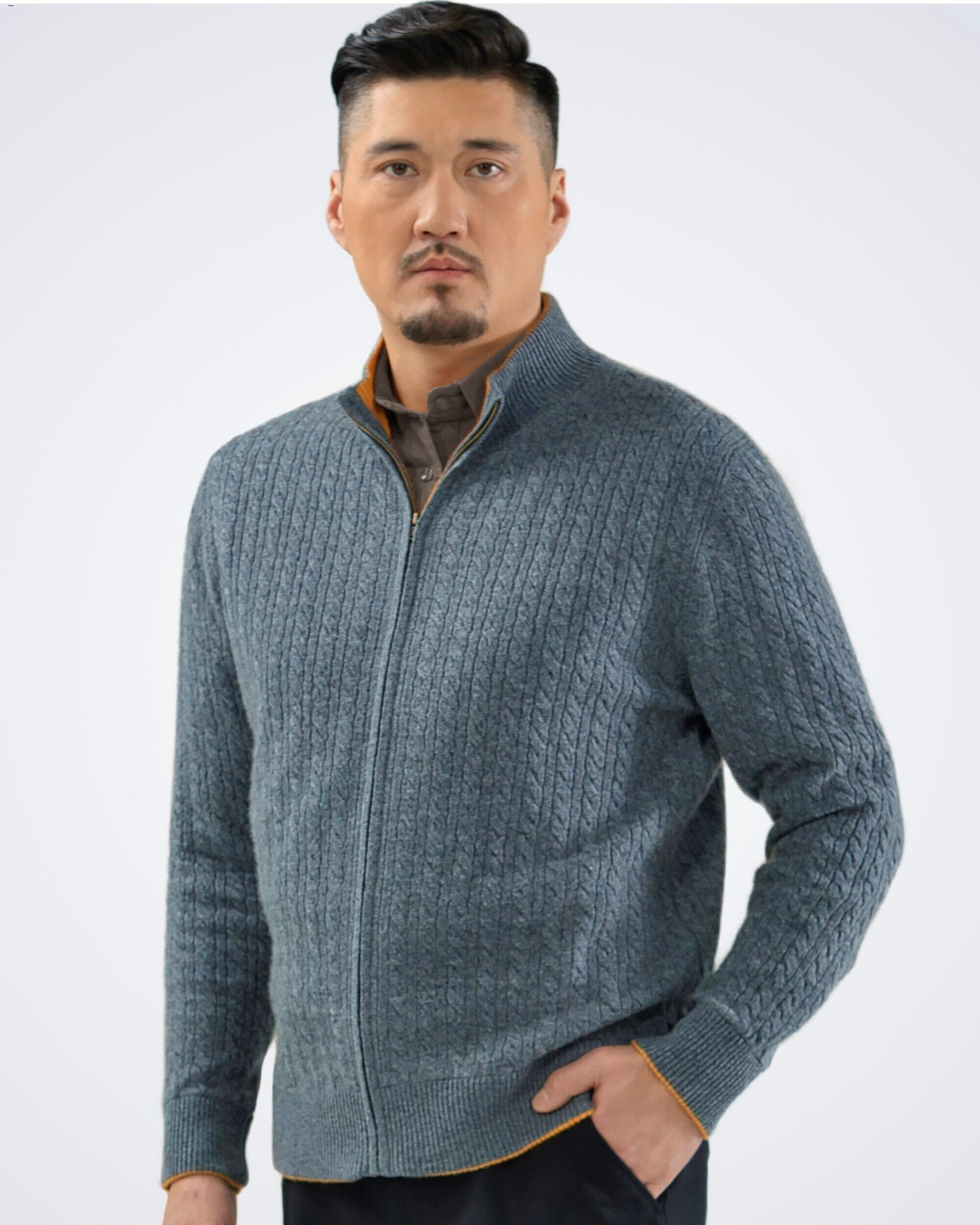Unur model wearing a men's luxury Mongolian cashmere cable knit cardigan in grey with orange accents