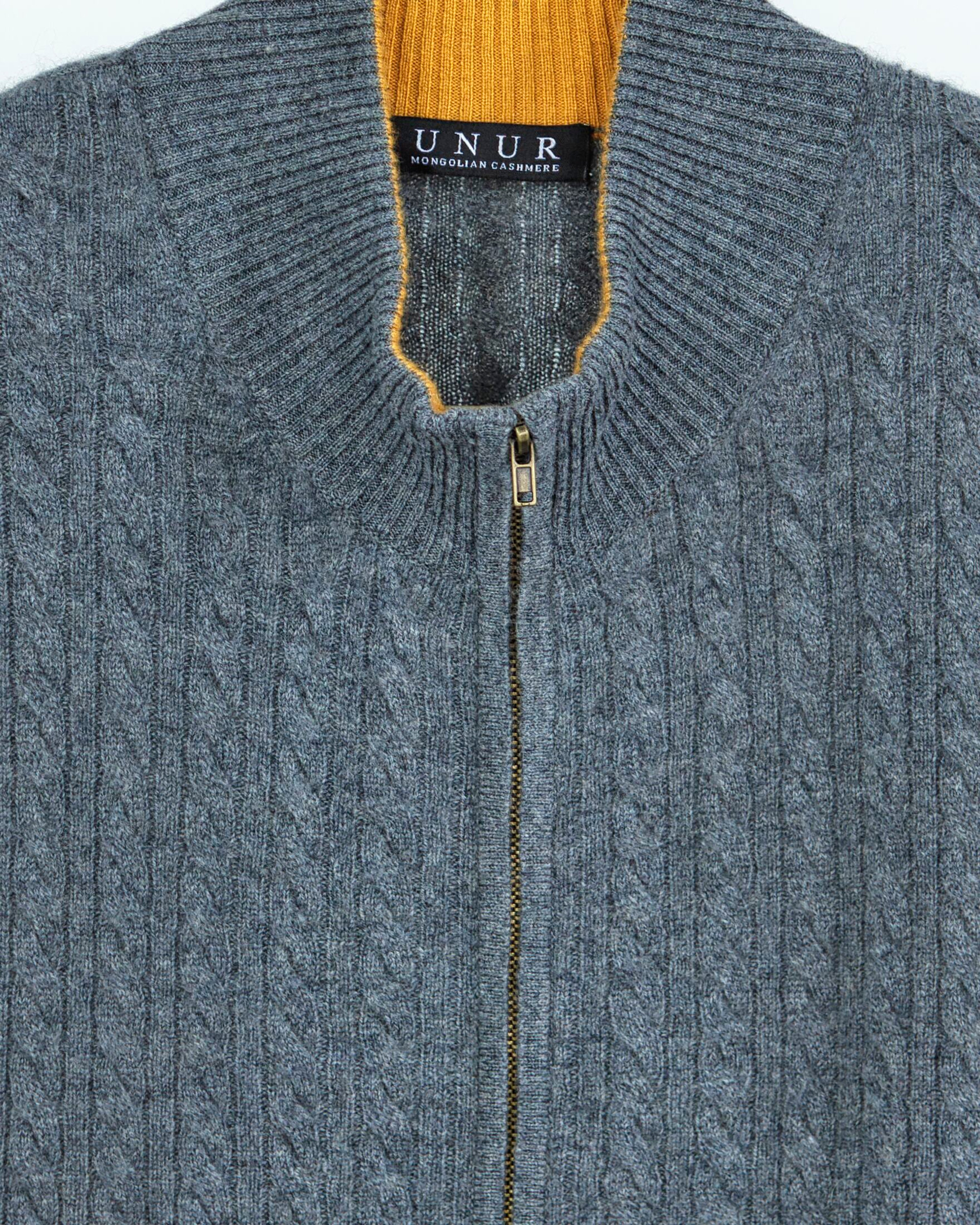 Close up of a grey cable knit cashmere cardigan with orange accents