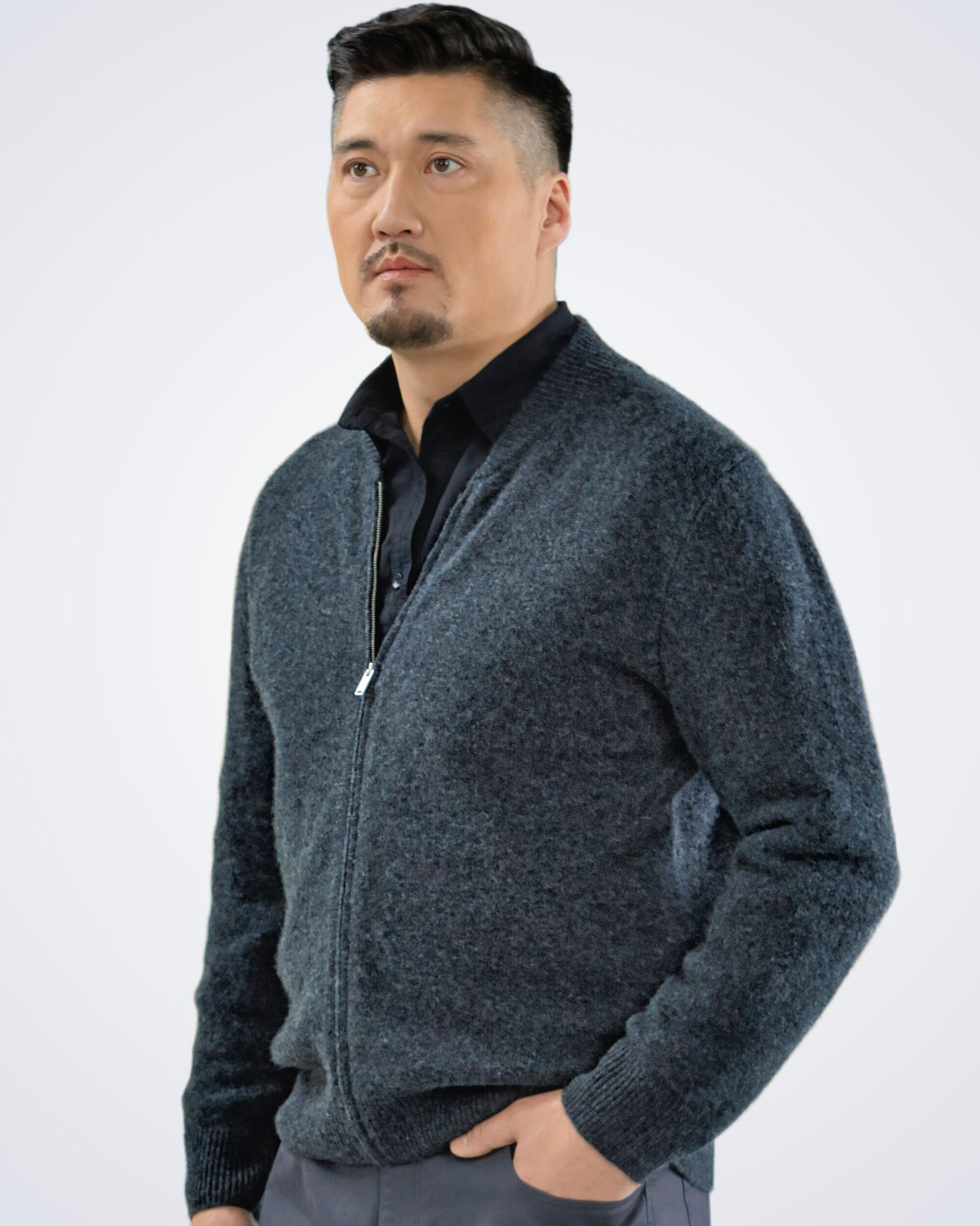 Unur model wearing a dark grey men's cashmere classic cardigan with ribbed details