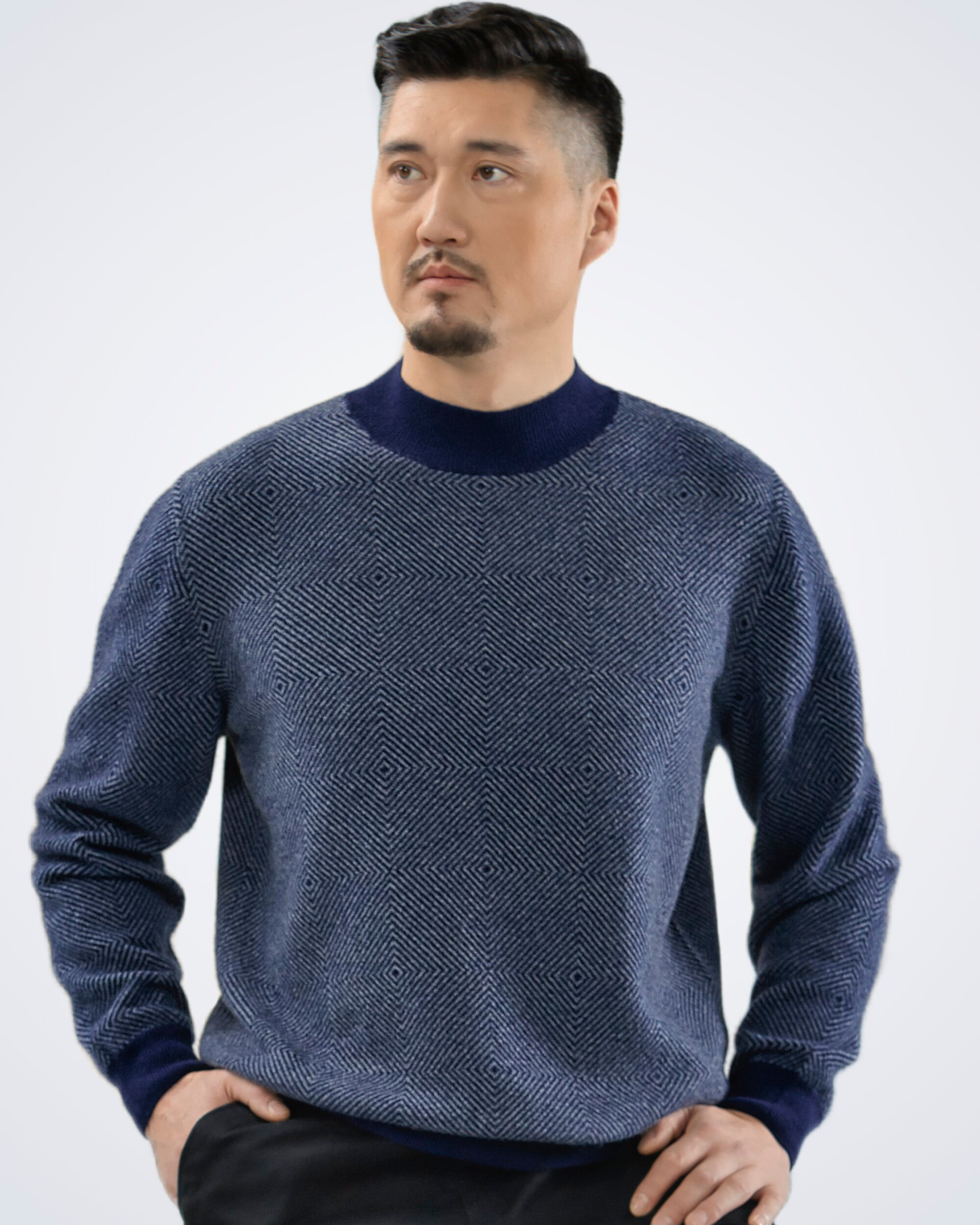 Unur model wearing a men's cashmere high neck jumper with diamond pattern in navy blue