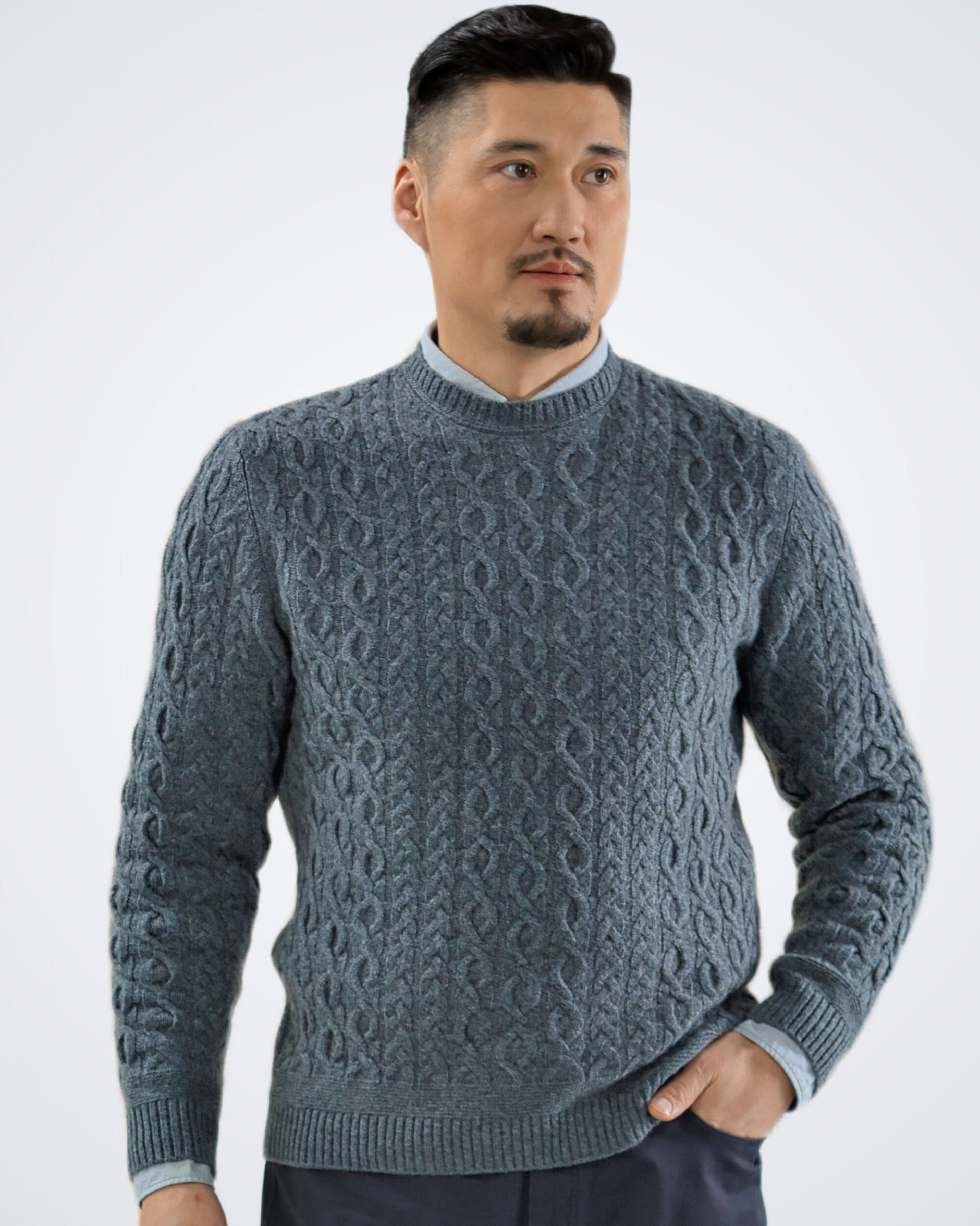 Unur model wearing a grey men's cashmere round neck cable knit jumper