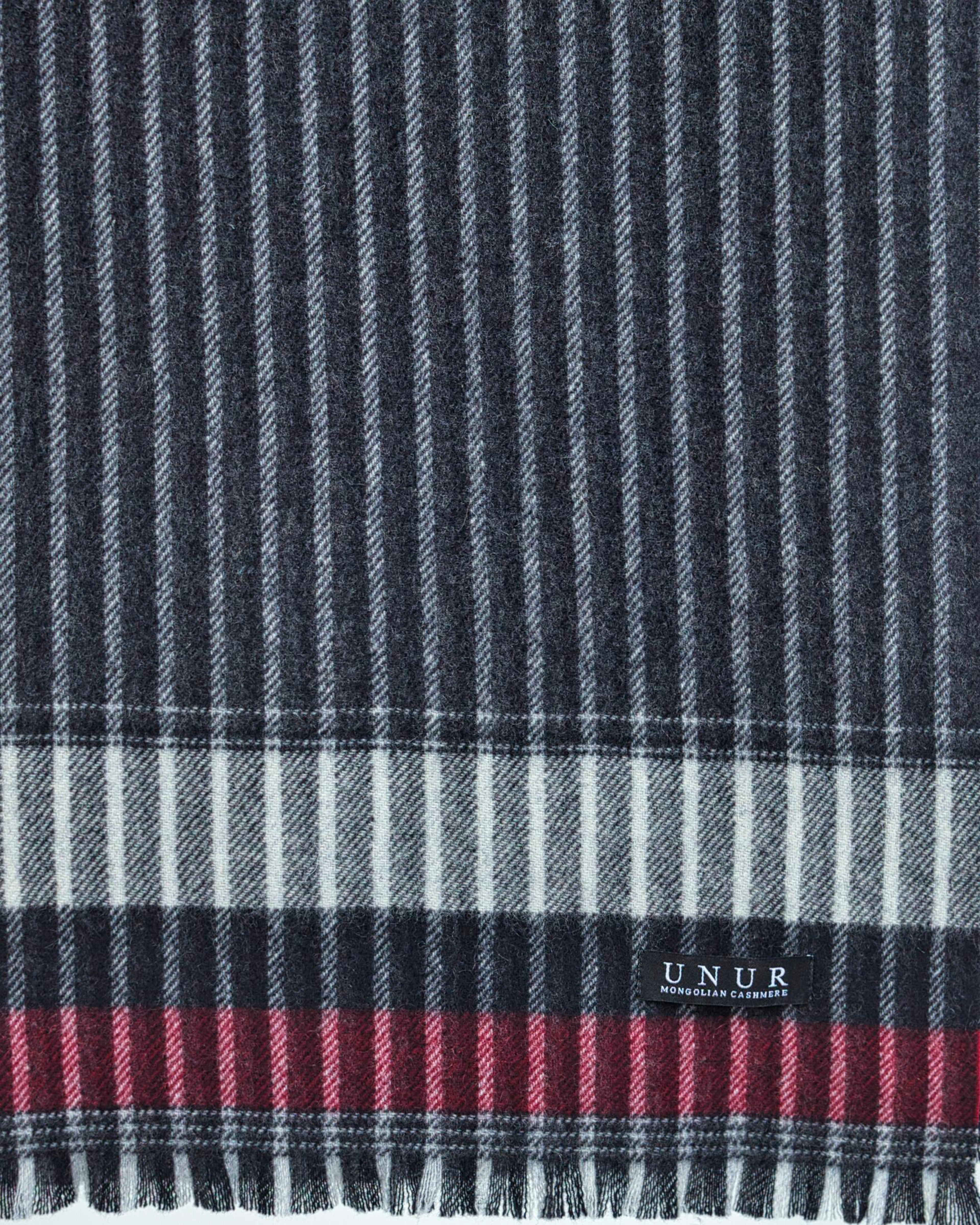 Close up of a pinstripe cashmere scarf with plaid end detail