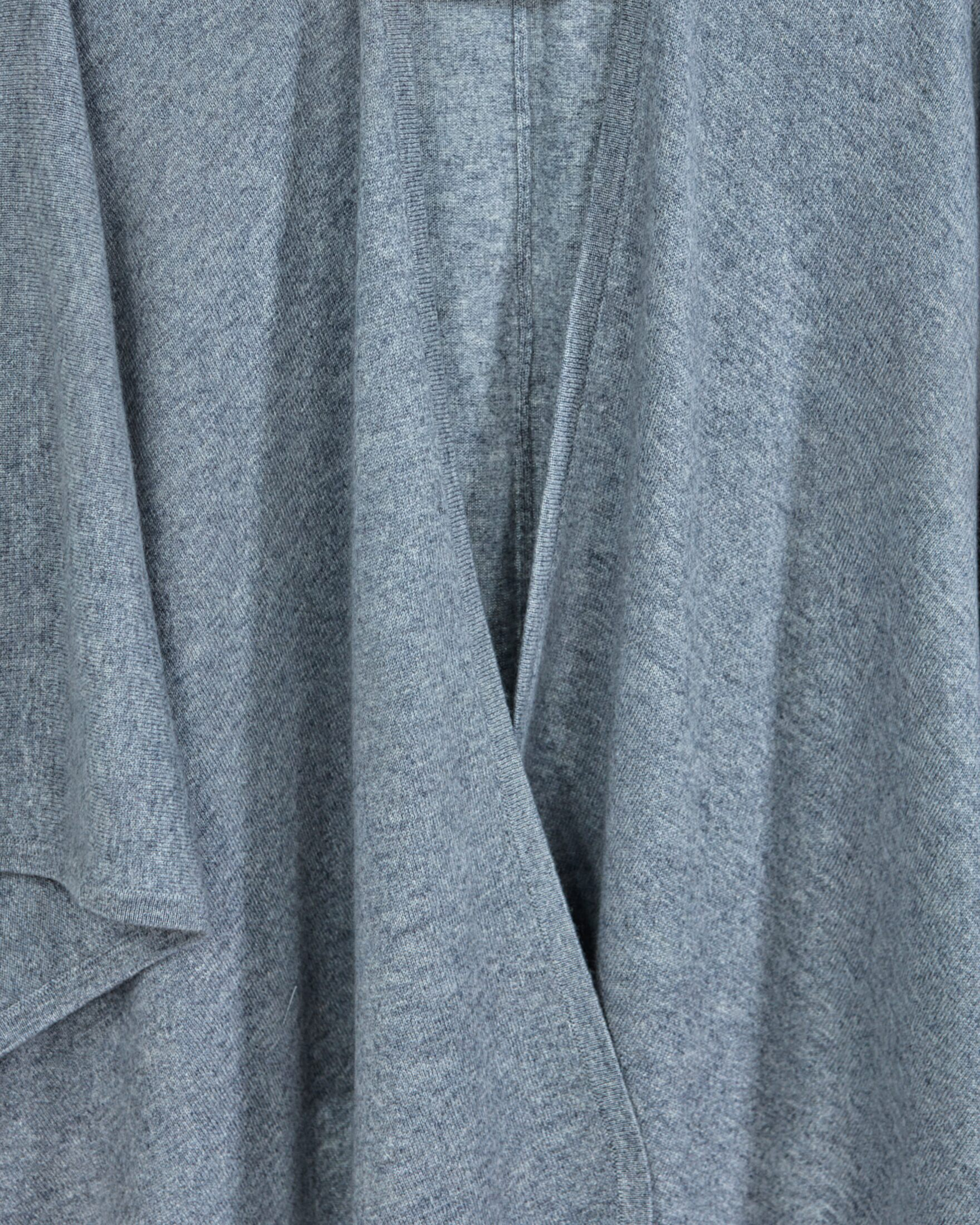 Close up of grey cashmere cape with a fluid silhouette